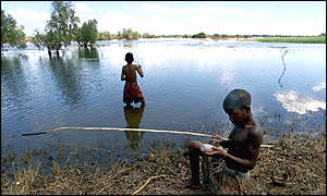 Boys fishing in flooded field near Chokwe